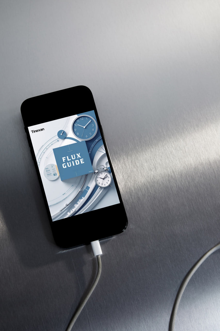 Smartphone with a digital clock app on a metallic surface